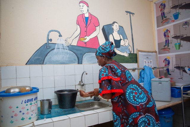 Sanata washing her hands inside the delivery room, at the community health centre of Touna. Credit: WaterAid/ Basile Ouedraogo.